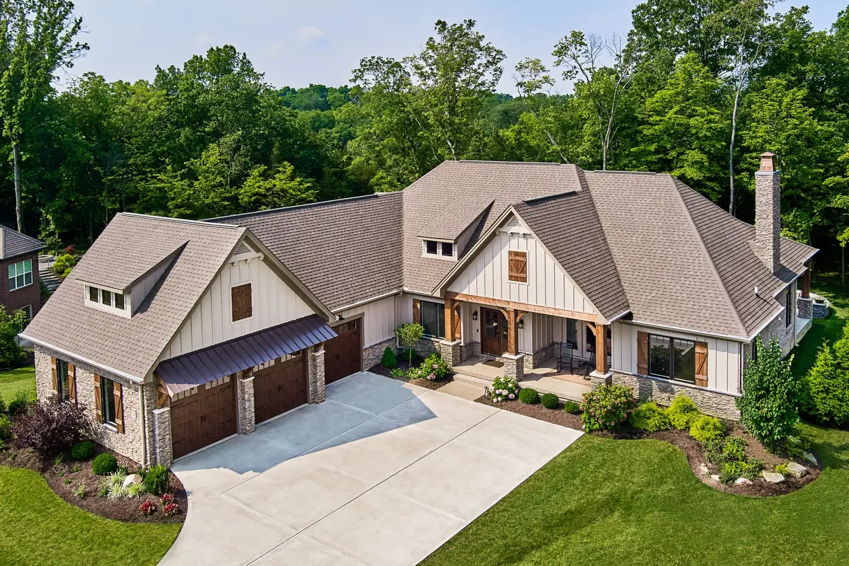 Craftsman ranch with stone and board-and-batten siding and an Atlas Pinnacle Pristine roof in Weathered Wood