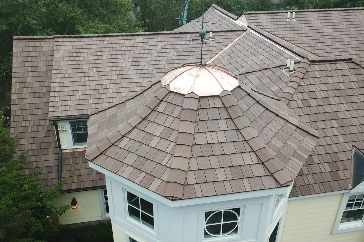 Octagonal turret on a DaVinci Multi-Width Shake roof in Autumn, with a copper cap and hip tiles