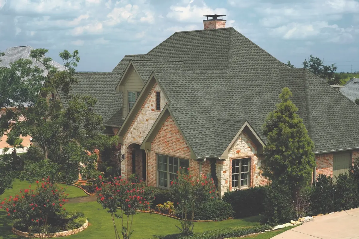 Brick and stone two-story home with a GAF Timberline HDZ roof in Slate