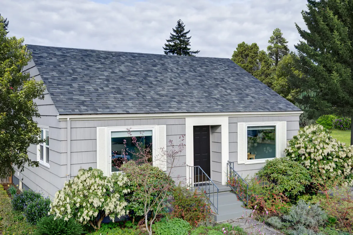 Gray-sided house with a Malarkey Vista AR roof in Storm Grey
