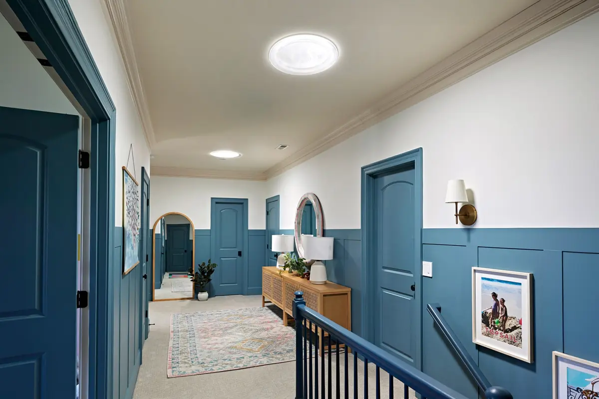 Upstairs hallway lit by a VELUX Sun Tunnel ceiling diffuser