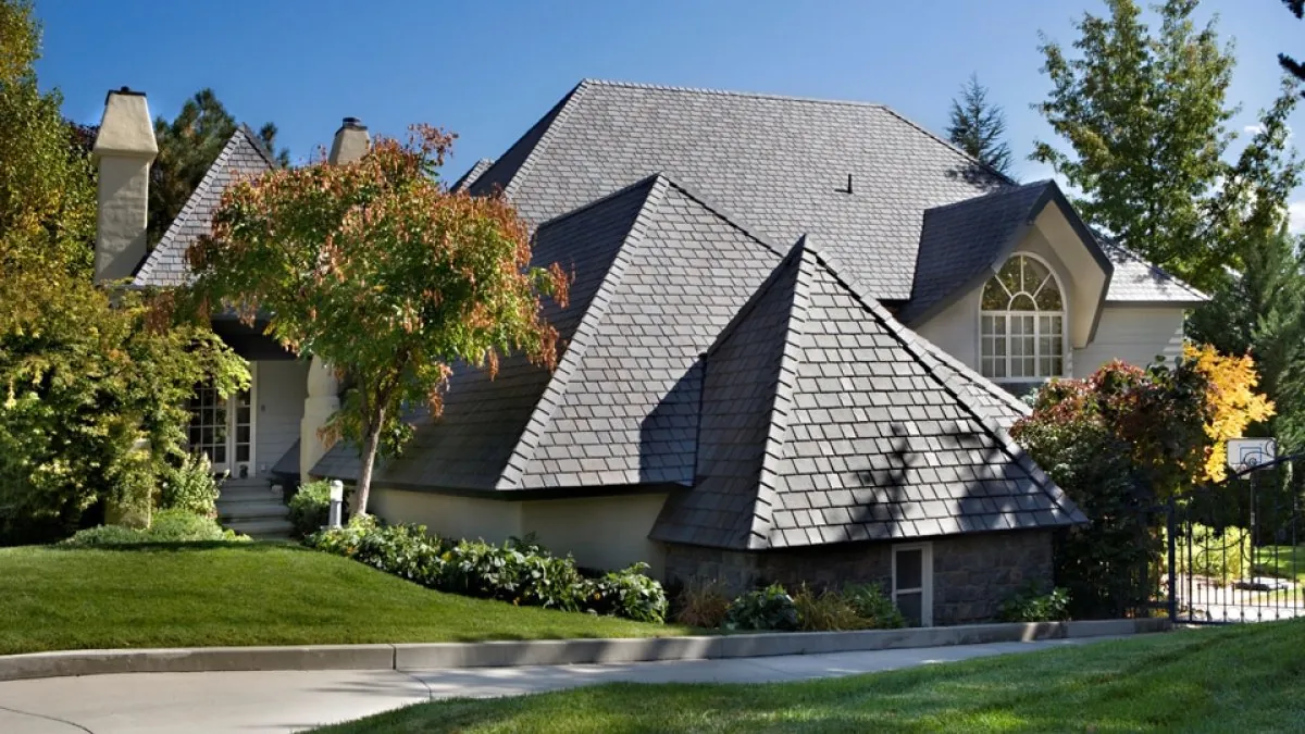 DaVinci Multi-Width Slate roof with steep hips and an arched-window dormer