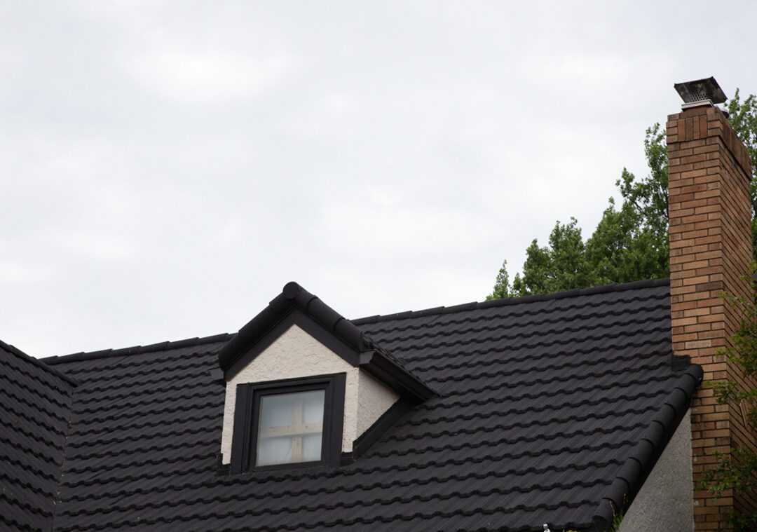 Unified Steel metal roofing with dormer and brick chimney detail
